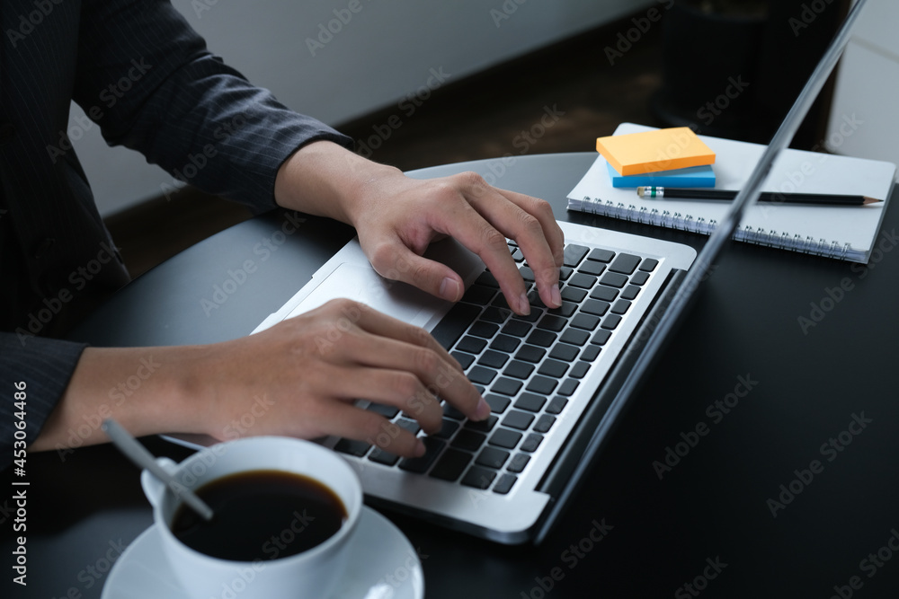 Closed up with businessman is typing something on his laptop on office desk. Closed up with businessman is typing something on his laptop on office desk.