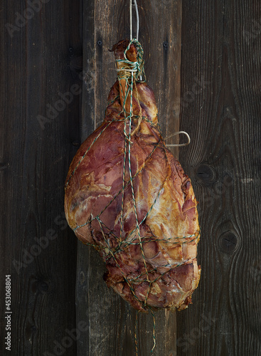 Smoked pork ham on wooden background