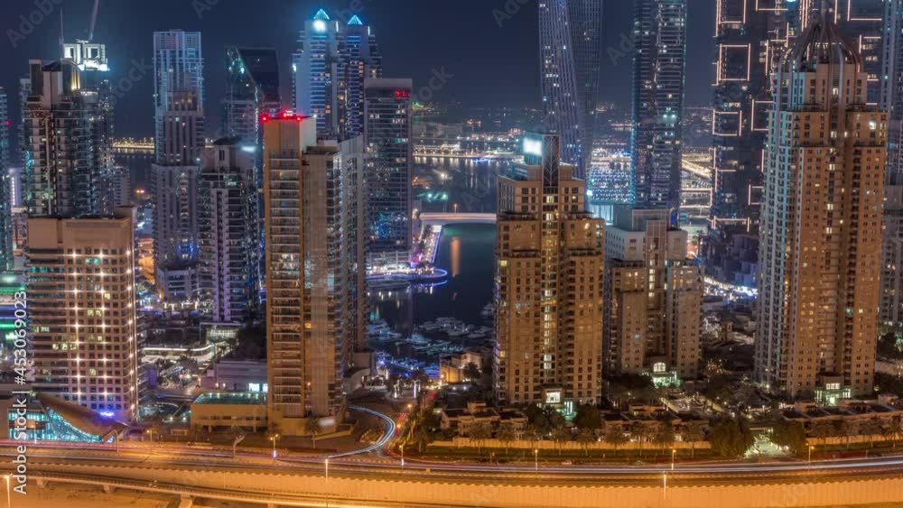 Skyscrapers of Dubai Marina near intersection on Sheikh Zayed Road with highest residential buildings all night timelapse Skyscrapers of Dubai Marina near intersection on Sheikh Zayed Road with highest residential buildings all night timelapse