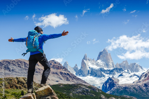 Active hiker hiking, enjoying the view, looking at Patagonia mountain landscape. Fitz Roy, Argentina. Mountaineering sport lifestyle concept photo