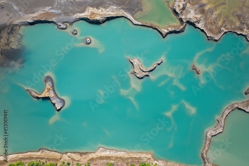 Drone view of the turquoise lake formed as a result of mining waste photo