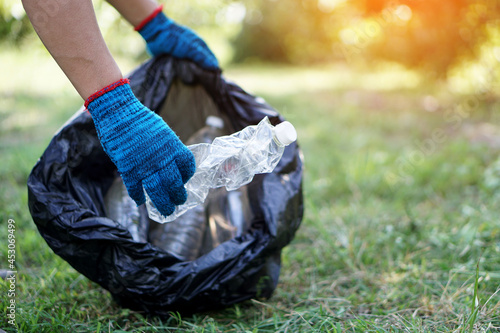 Concept : Environment conservation. Volunteer pick up bottle garbage that other people threw away and left in the park. Cleaning public place activity. Recycle waste. 