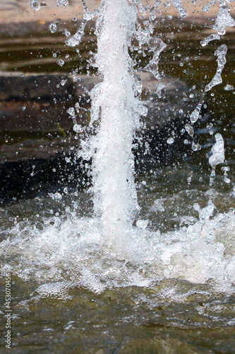 Out of focus, blurry background, splashes of water from the fountain.