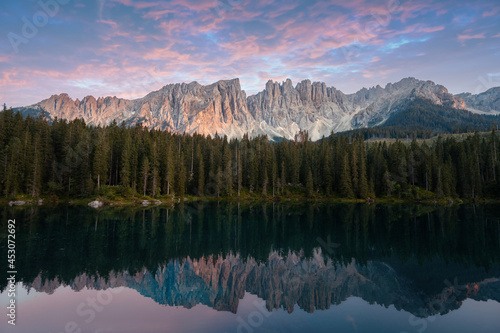 Wallpaper Mural Wonderful typical alpine landscape (Lago di Carezza) in the Dolomites, South Tyrol. Latemar mountains and a pine forest are reflected in the clear lake at sunset. No people, peace and quiet. Torontodigital.ca