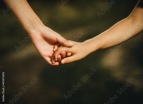 children holding hands close-up for background