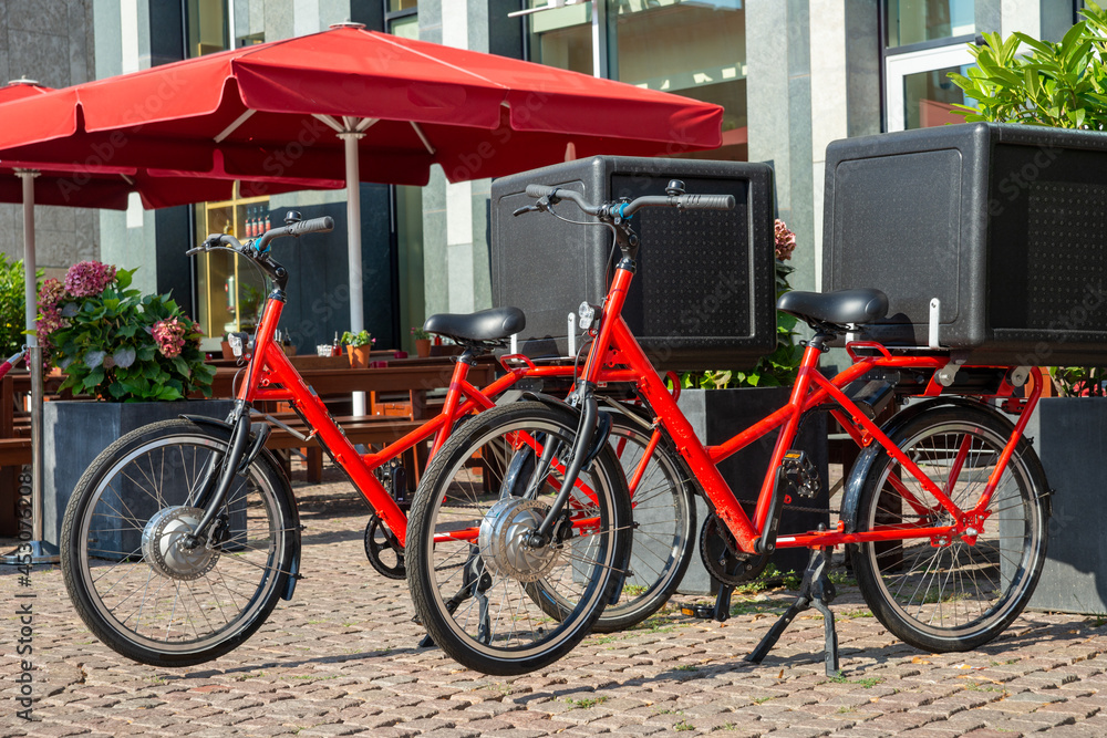 two red bikes with black delivery boxes