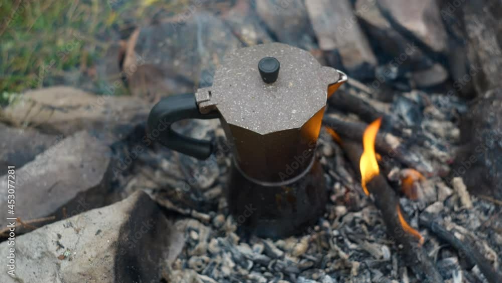 Coffee is prepared in a geyser coffee maker on a campfire Coffee is prepared in a geyser coffee maker on a campfire