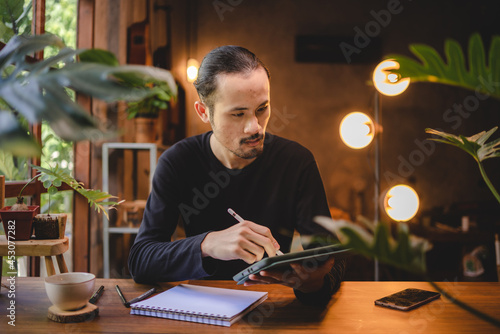 using professional digital tablet technology to write a business work  modern online screen cyberspace communication  hand writing via white pen  lifestyle same laptop computer or notebook using