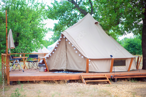 View of modern camping tents in the glamping area. Camping tent with all the amenities.