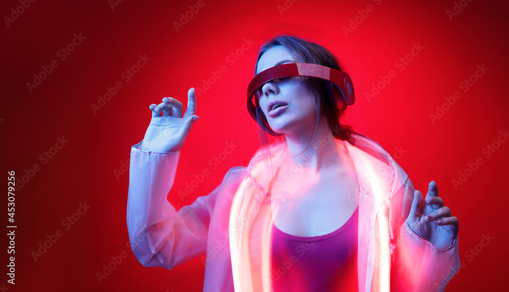 Woman in futuristic costume. Girl in glasses of virtual reality while ...