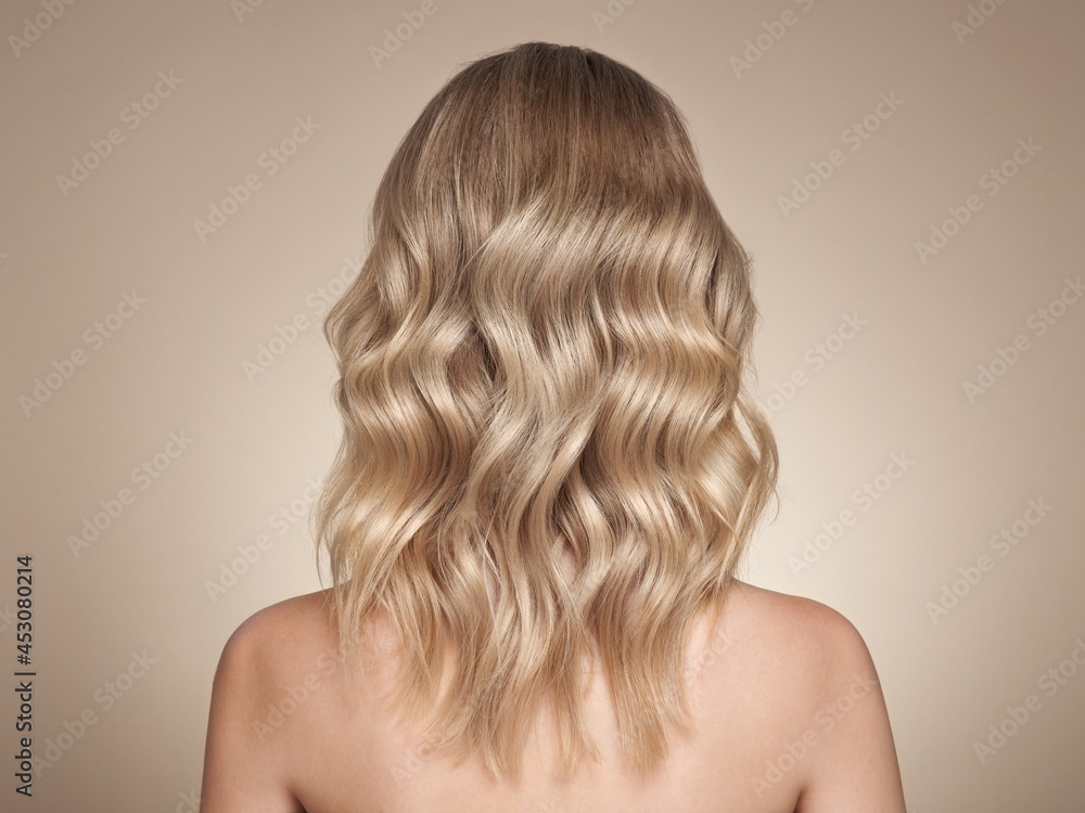 Fototapeta premium Blonde woman with long curly hair