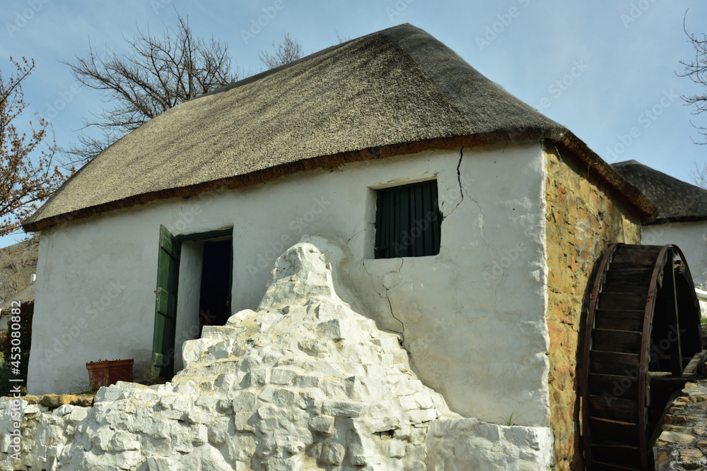 An old Cape Dutch mill-house complete with waterwheel in the Western Cape