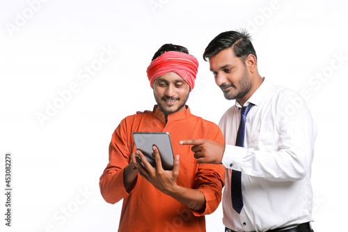 Technology concept : Bank officer or government employee showing some detail to farmer in tablet