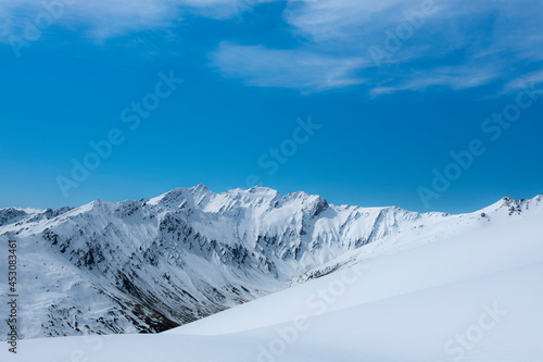 Snow covered mountain landscape with powdery slopes in the south island of New Zealand on a sunny day