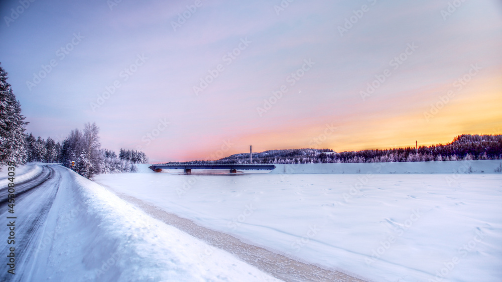 Winterly landscape with bridge over Skellefte river in Swedish Lapland