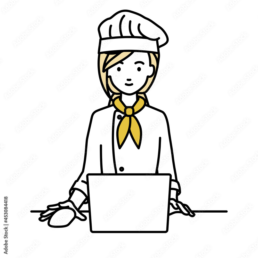 デスクで座ってPCを使っている調理師の女性