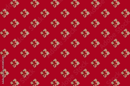 Pattern of gift boxes with a bow made with ribbon isolated on a red background
