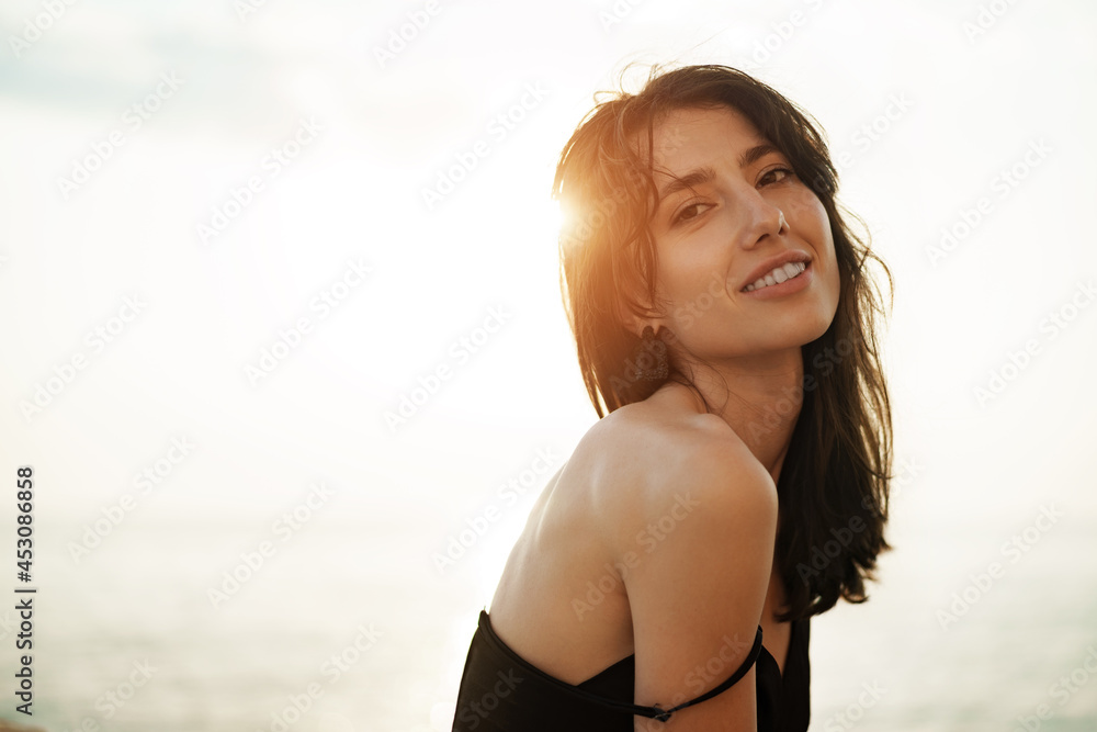 Young smiling woman outdoors portrait at beach Young smiling woman outdoors portrait at beach