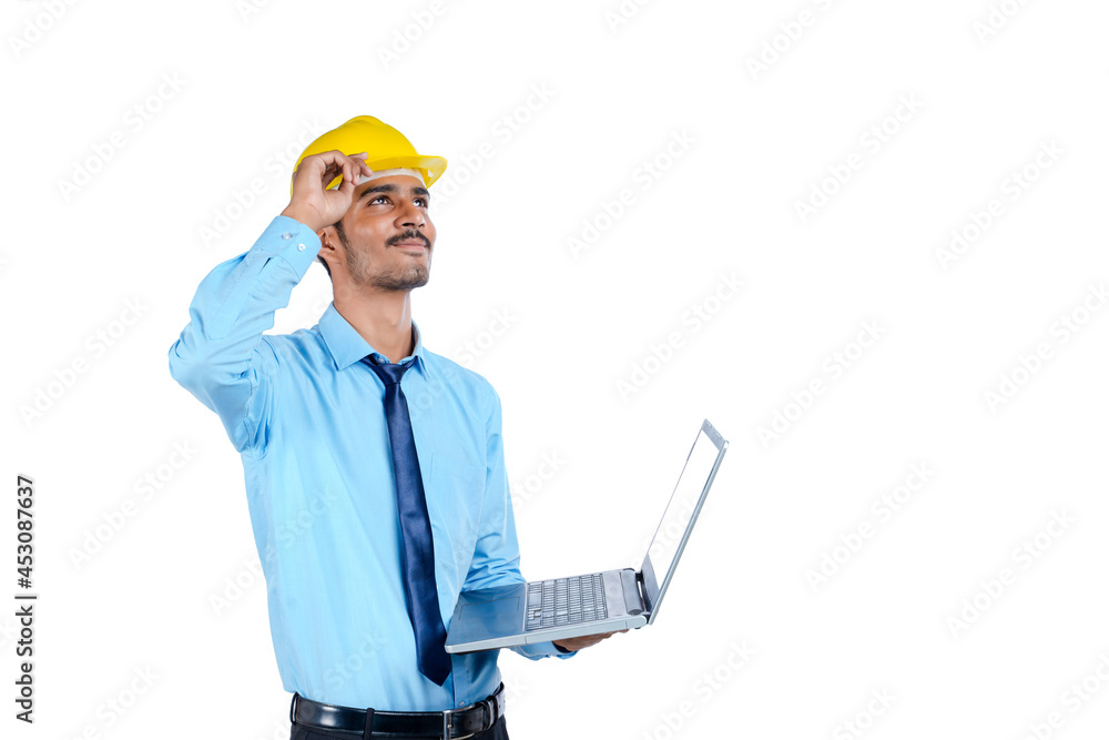 young Indian engineer in uniform and using laptop on white background. young Indian engineer in uniform and using laptop on white background.