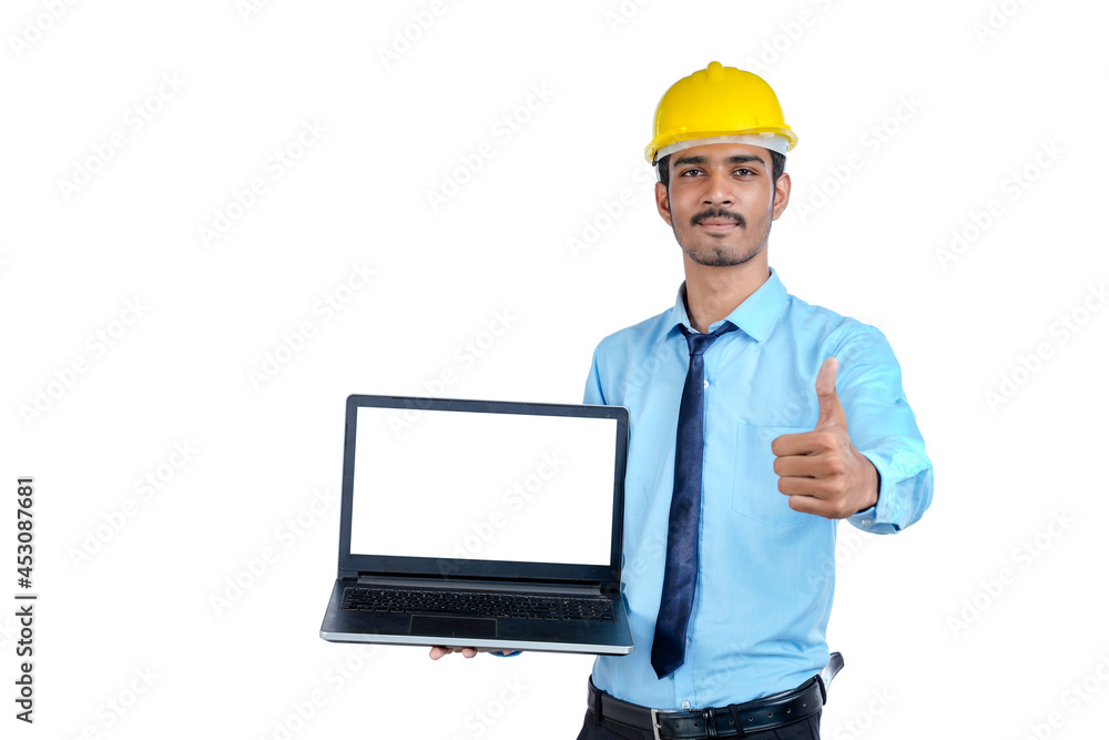 Indian engineer showing laptop empty screen on white background. Indian engineer showing laptop empty screen on white background.