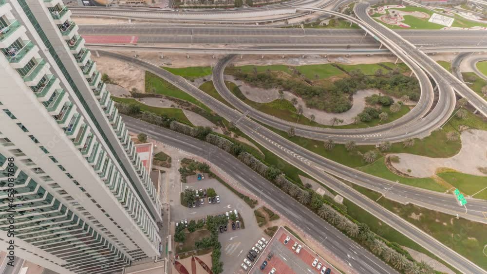 Aerial view on Dubai Marina with big highway intersection timelapse and skyscrapers around, UAE Aerial view on Dubai Marina with big highway intersection timelapse and skyscrapers around, UAE