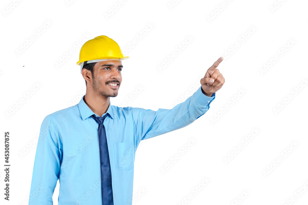Young Indian engineer wearing yellow color hard hat and giving successful gesture. Young Indian engineer wearing yellow color hard hat and giving successful gesture.
