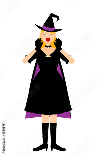 ハロウィンの仮装、魔女姿の女性が両手を構えて驚かせるポーズ