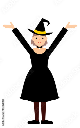ハロウィンの仮装、魔女姿の女の子が両腕を上げるポーズ