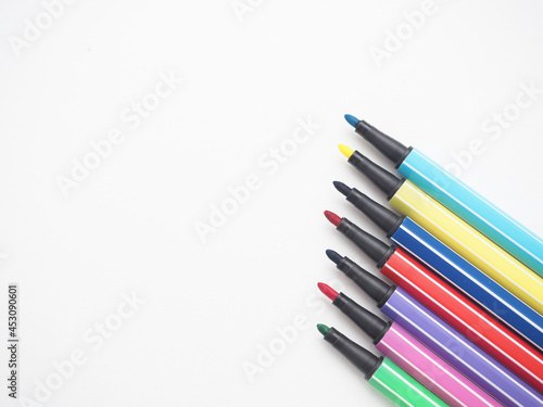 Close up color pen different array on white isolated top view copy space
