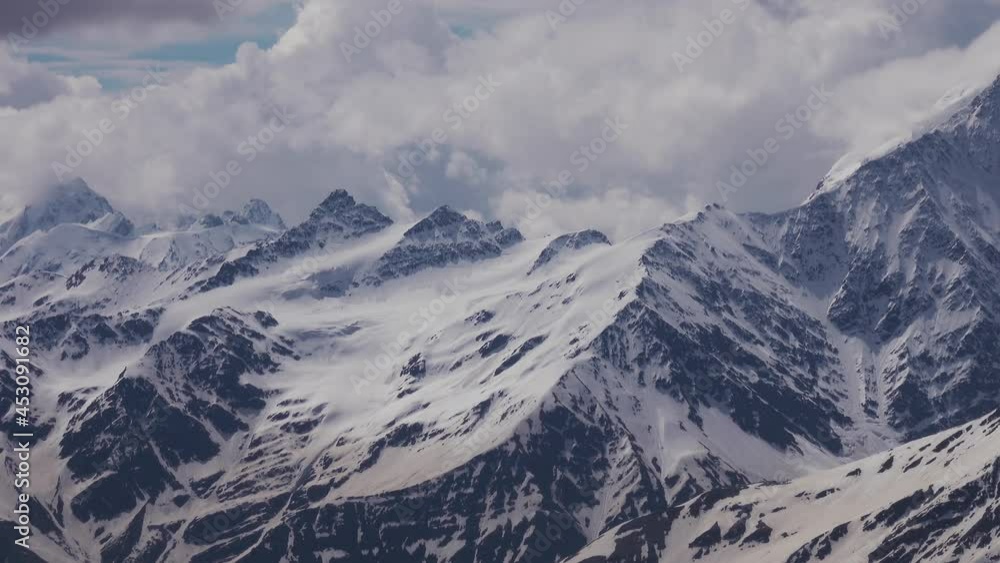 Snow-Capped Pinnacles of the Caucasus Mountains. View from Elbrus on Clear Sunny Day Snow-Capped Pinnacles of the Caucasus Mountains. View from Elbrus on Clear Sunny Day