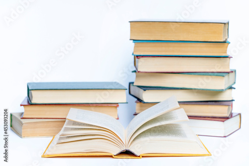 Opened Book and stacks old books on white background. Education learning concept
