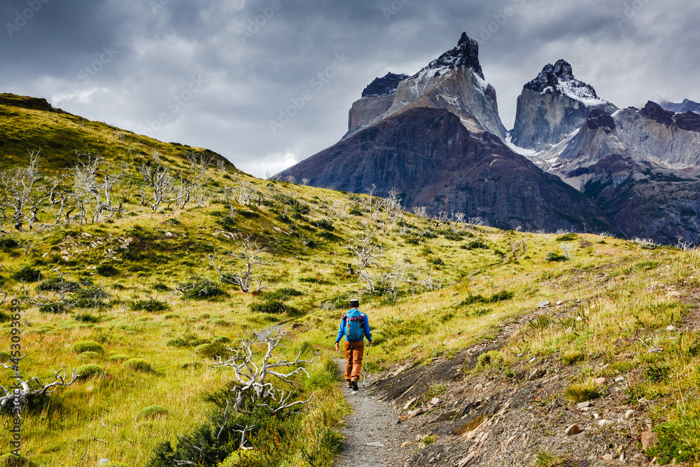 Traveler with Backpack hiking in Torres del Paine national park, Patagonia, Chile