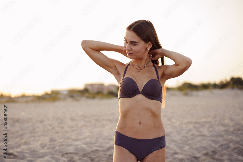 Photo of young attractive woman in bikini on beach Photo of young attractive woman in bikini on beach