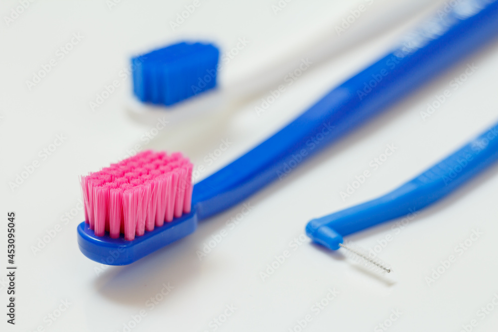 Toothbrushes and interdental brush on the white background. Toothbrushes and interdental brush on the white background.