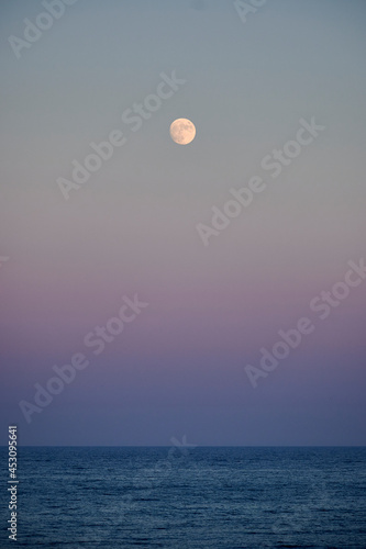 Fototapeta Naklejka Na Ścianę i Meble -  Full moon over the sea at sunset