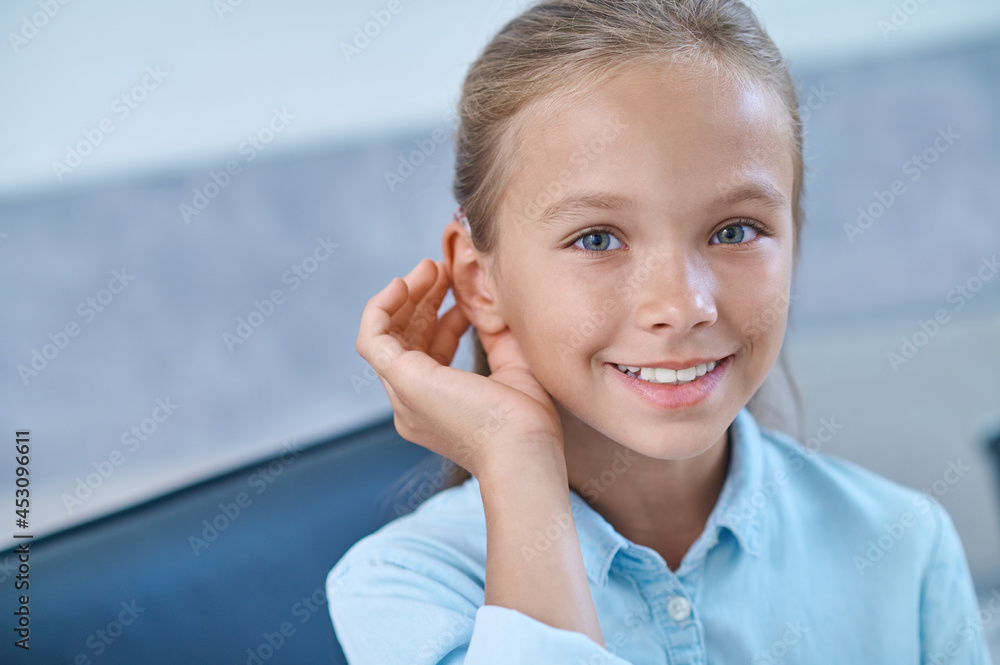 Hearing impaired girl trying hearing aid Hearing impaired girl trying hearing aid