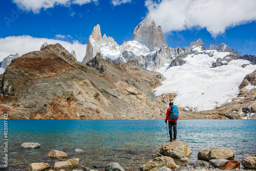Active hiker hiking, enjoying the view, looking at Patagonia mountain landscape. mountaineering sport lifestyle concept
