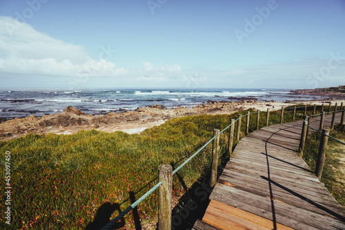 wooden walkway on the beach near the sea photo