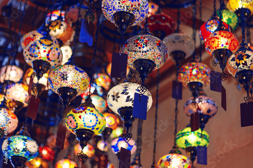 Middle Eastern lamps of different colors hanging in bazaar