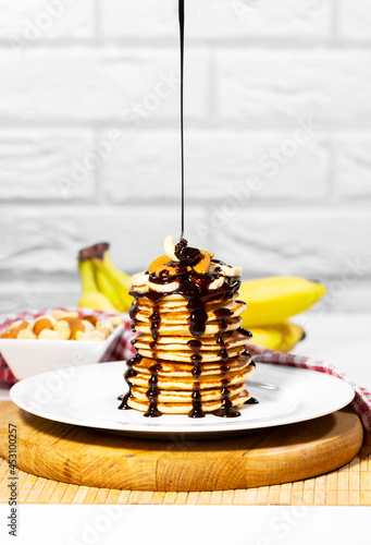 Tableau sur toile Pancakes with Chocolate Syrup, Nuts and Bananas