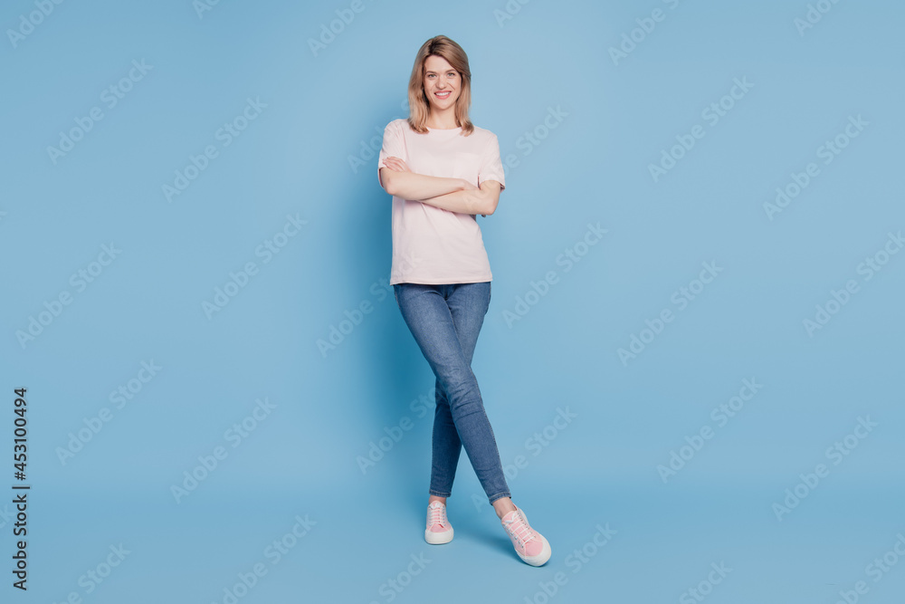 Portrait of charming confident lady hands crossed tempting posing on blue background Portrait of charming confident lady hands crossed tempting posing on blue background
