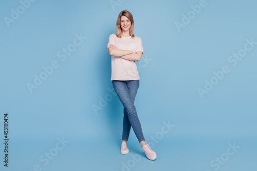 Portrait of charming confident lady hands crossed tempting posing on blue background