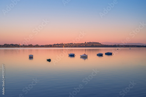 Fototapeta Naklejka Na Ścianę i Meble -  Evening at the lake in Imielin, Silesia, Poland. Little sailboats flowing on the water surface. Mountains silhouette in the background. Beautiful, colorful sky.