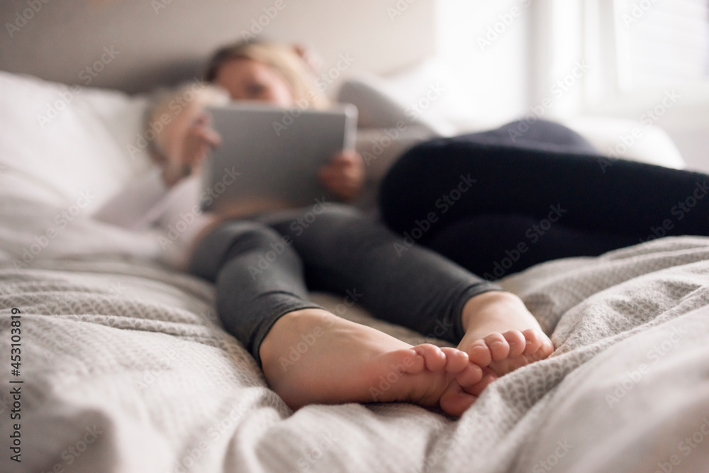 Mother and daughter using tablet in bed Mother and daughter using tablet in bed