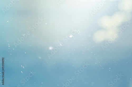 blue abstract background with blurred particles