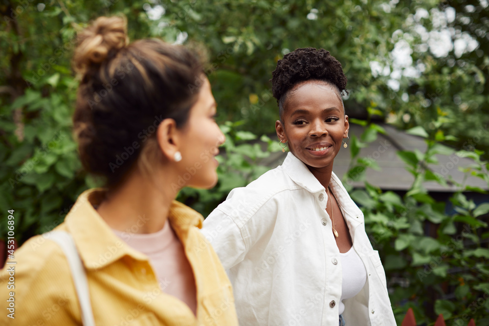 Smiling female friends talking Smiling female friends talking