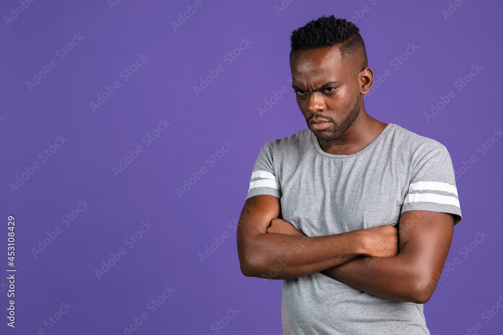 African-american young man's portrait on purple color studio background. Concept of human emotions, facial expression, youth, feelings, ad. African-american young man's portrait on purple color studio background. Concept of human emotions, facial expression, youth, feelings, ad.