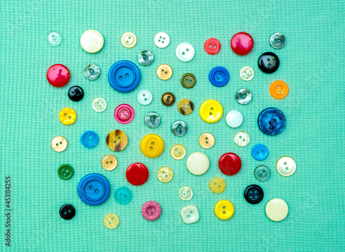 Bright mint textile and colorful buttons