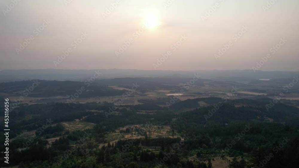 Aerial view of sunset in a smoke filled sky from distant forest fires, forward flight Aerial view of sunset in a smoke filled sky from distant forest fires, forward flight