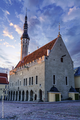 Tallinn medieval town hall at golden sunrise with dramatic sky. Estonia.